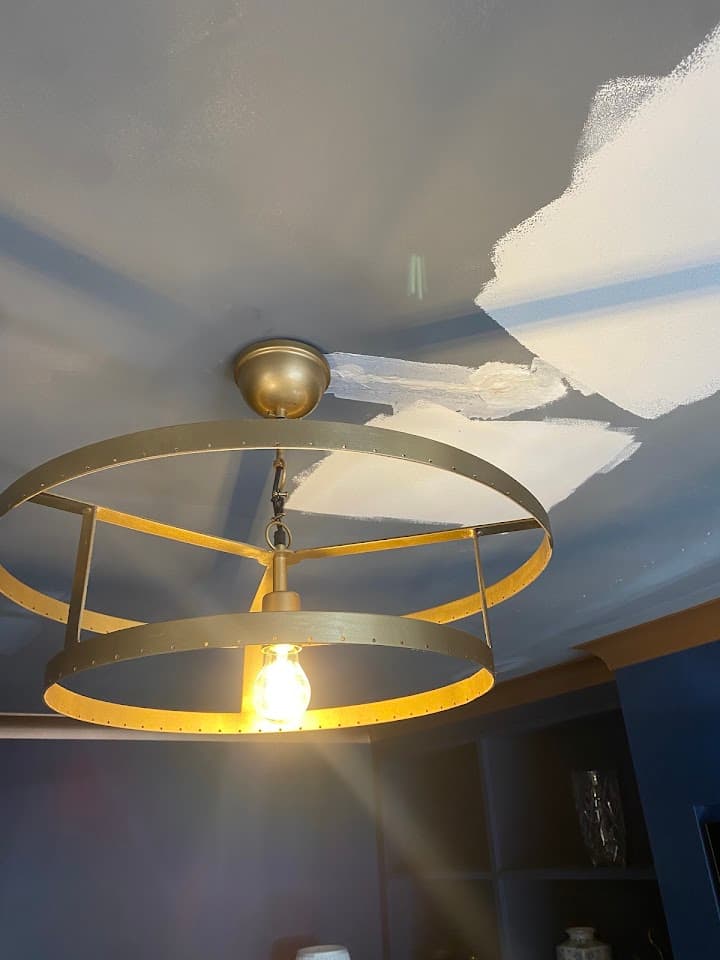 Modern brass ceiling light fitted and working in a living room