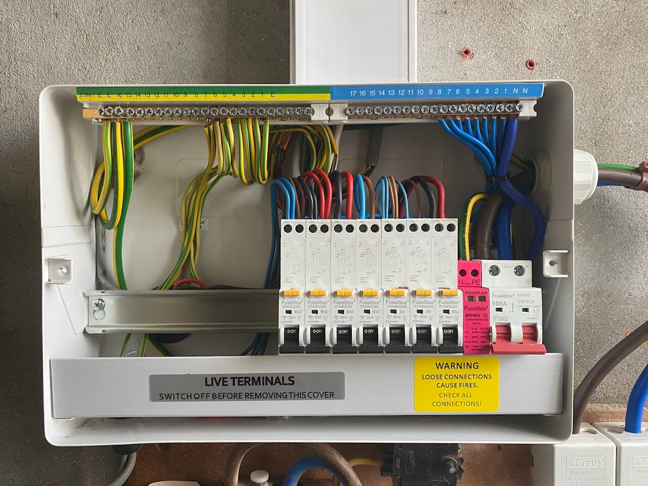 Inside a new consumer unit, showing tidy colour-coded wiring
