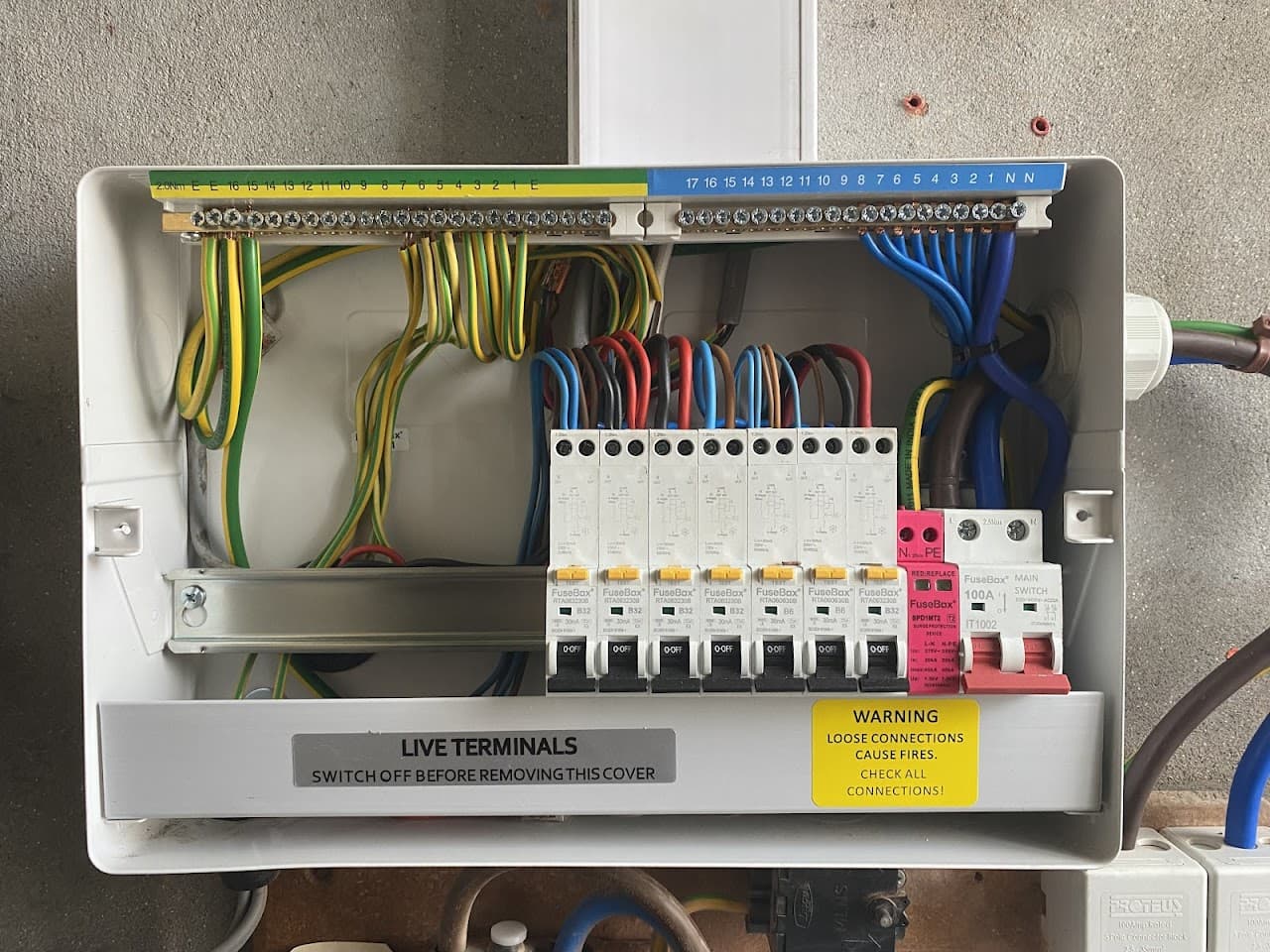 Inside a new consumer unit, showing tidy colour-coded wiring