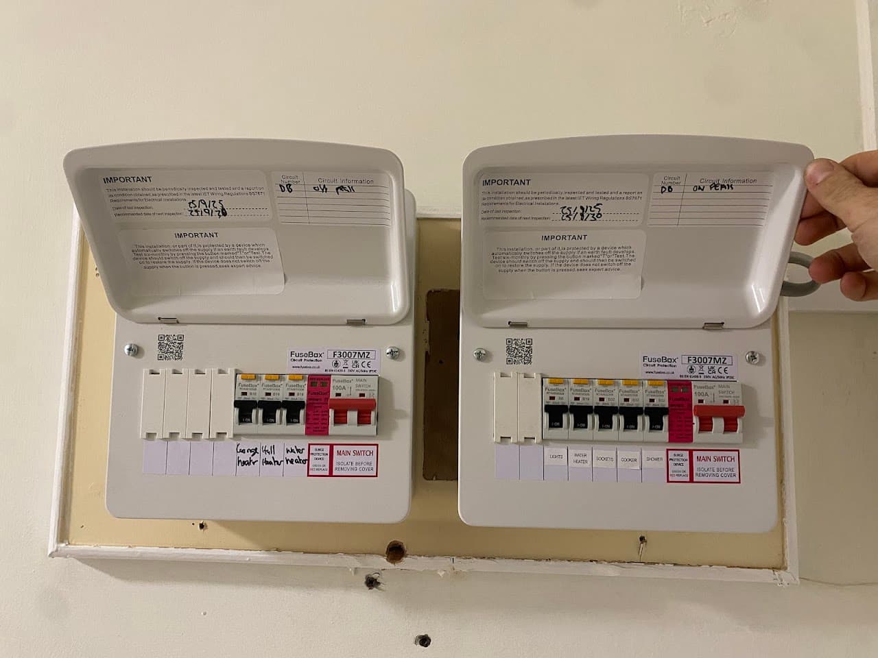 Two new consumer units fitted side by side, neatly wired and labelled