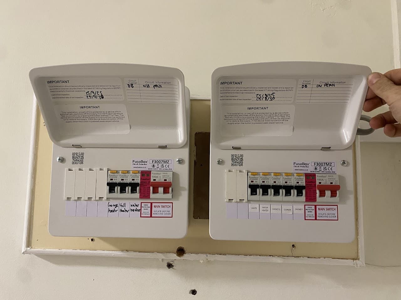Two new consumer units fitted side by side, neatly wired and labelled