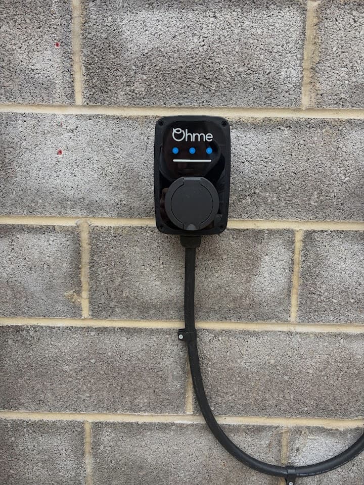 Ohme EV charger installed on the outside wall of a Bristol home