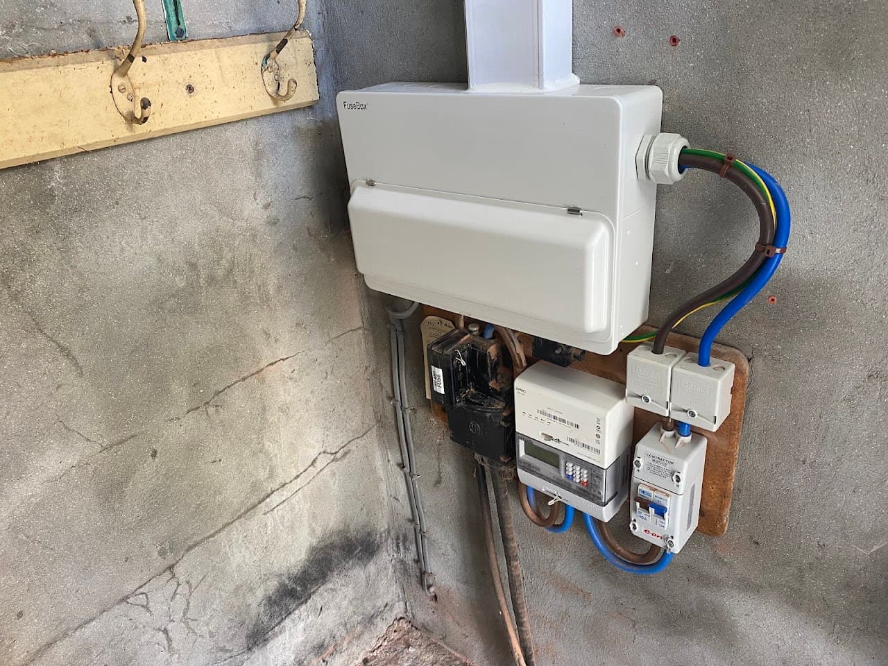 EV charger and isolator fitted to a garage with the supply run in armoured cable